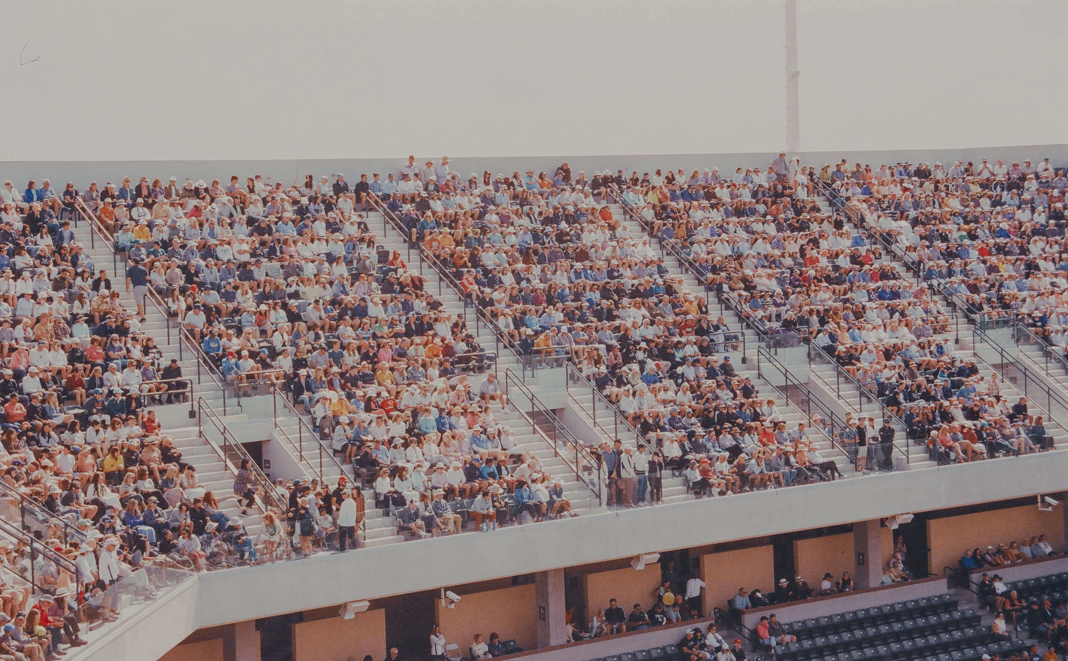 Stadium bleachers filled with thousands of spectators, showcasing the massive scale and market reach that entrepreneurial ventures can achieve when exceptional teams meet large audiences